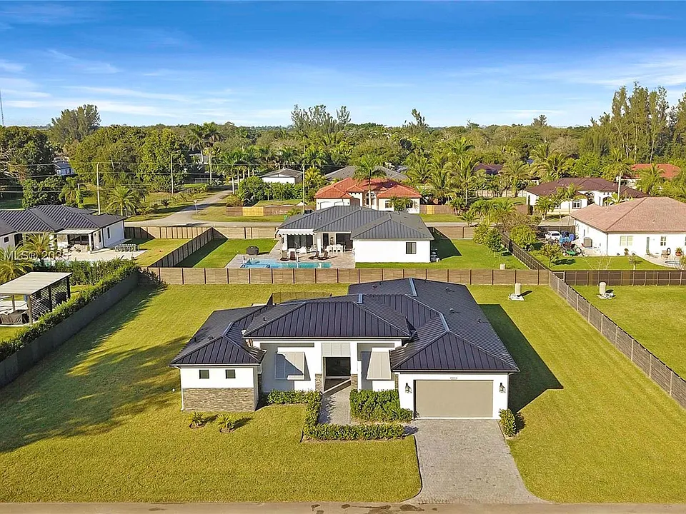 Aerial photograph of a single-story home with metal roof and pool, listed in south Miami-Dade